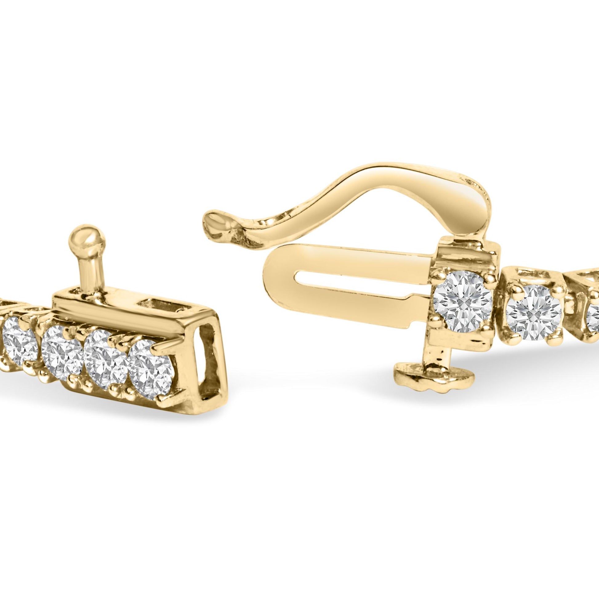 Close-up angled view of a yellow metal bracelet clasp featuring round white gemstones in four-prong settings.