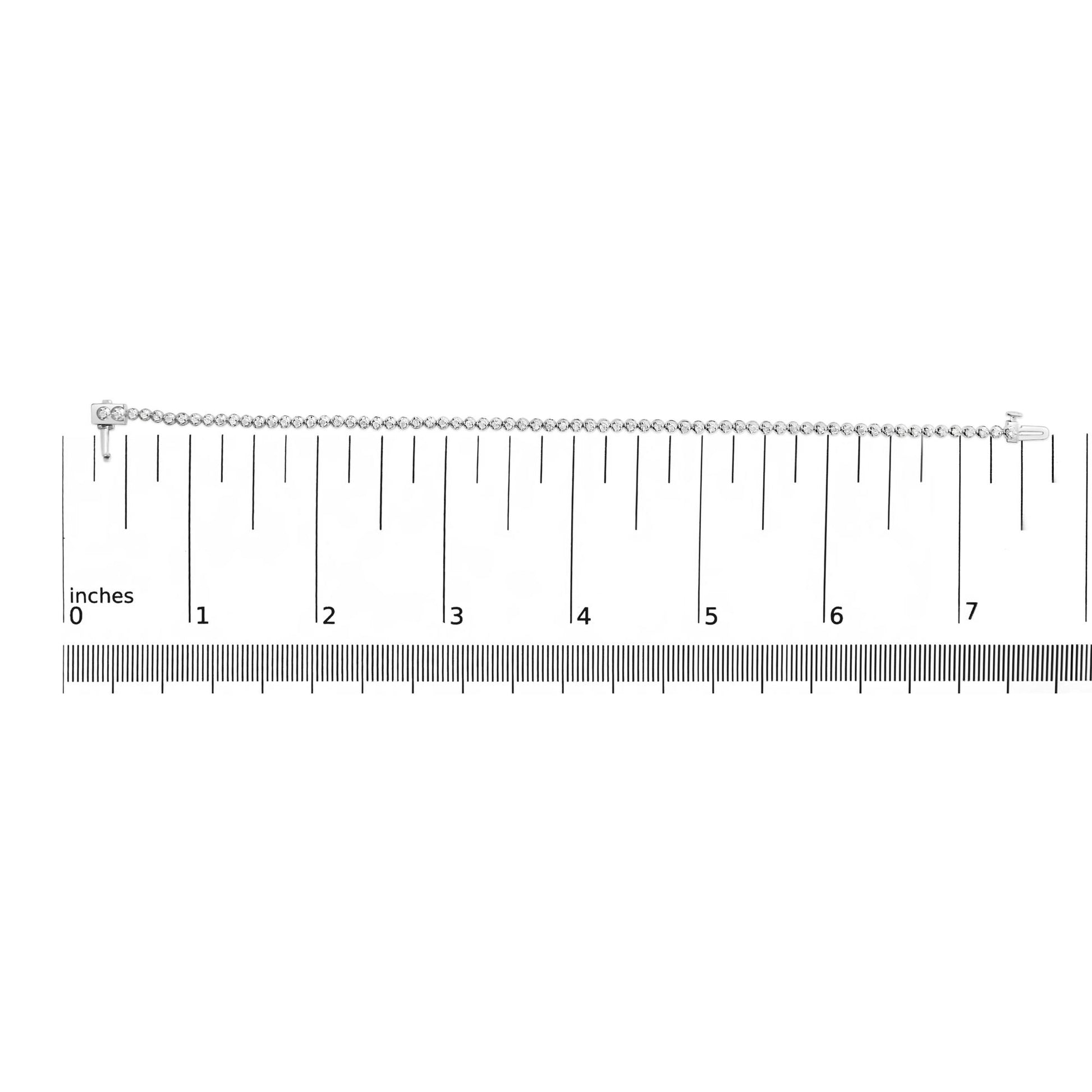 White bracelet with round white gemstones in prong settings shown on a ruler scale, front view.