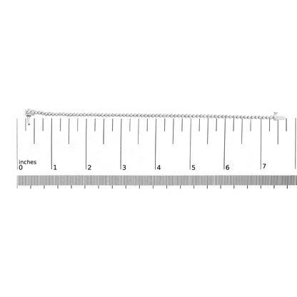 White bracelet with round white gemstones in prong settings shown on a ruler scale, front view.