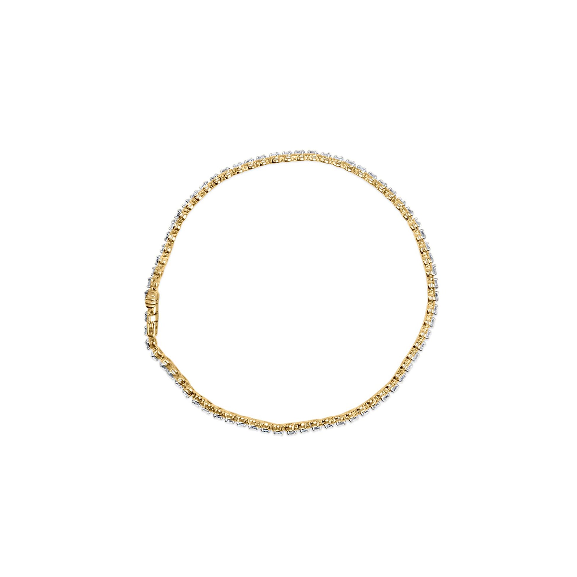 Top-down view of a yellow metal bracelet set with round white gemstones in prong settings, laid flat on a white background.
