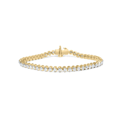 Yellow metal bracelet with prong-set round white gemstones, front-facing angle.