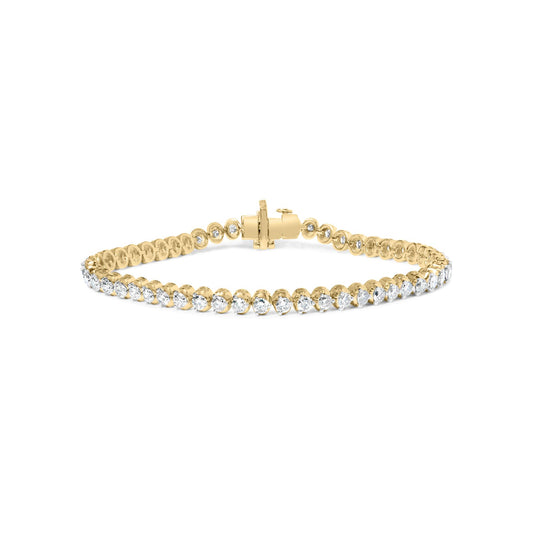 Yellow metal bracelet with prong-set round white gemstones, front-facing angle.