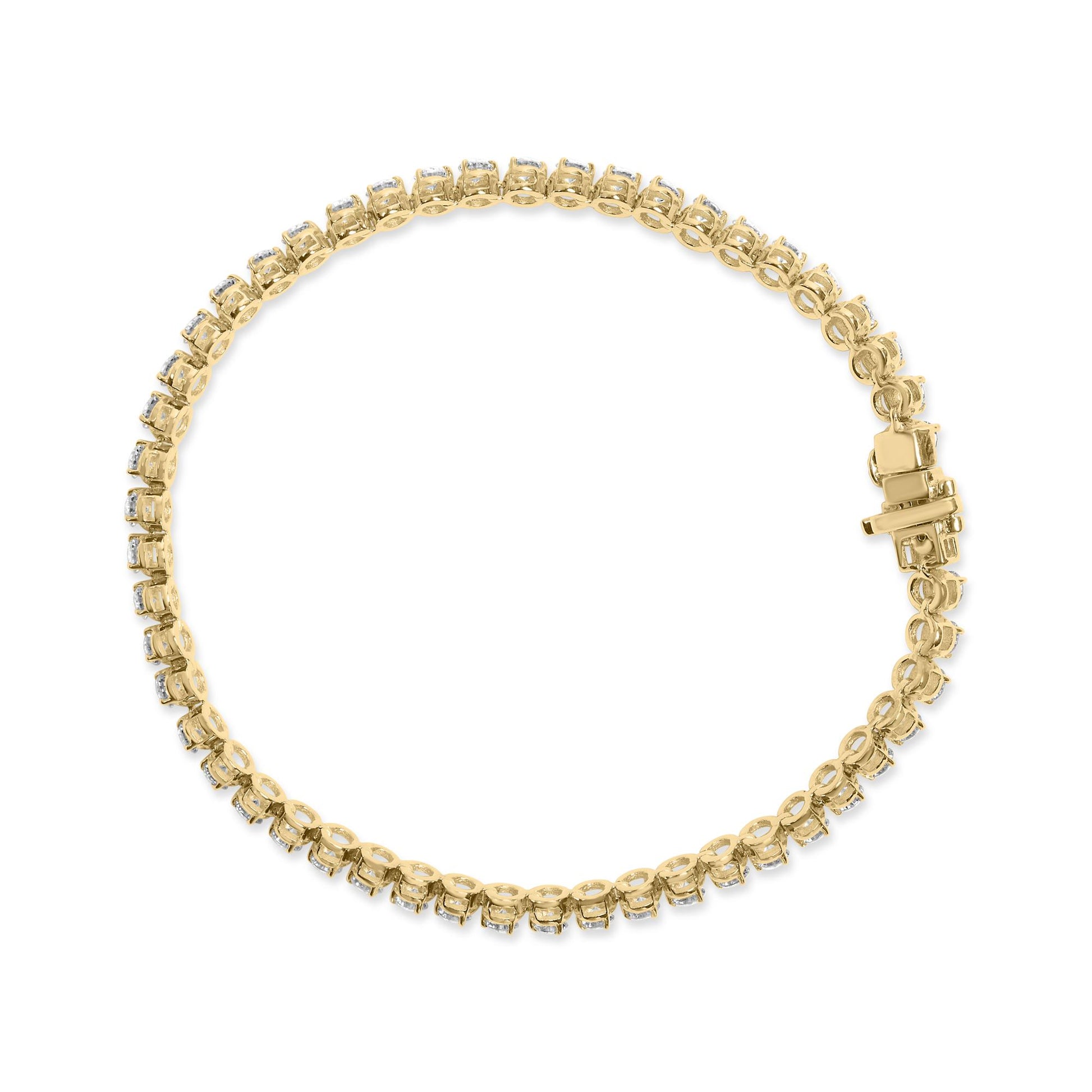 Top-down view of a yellow metal bracelet with round white gemstones in prong settings encircling the entire piece and a box clasp closure.