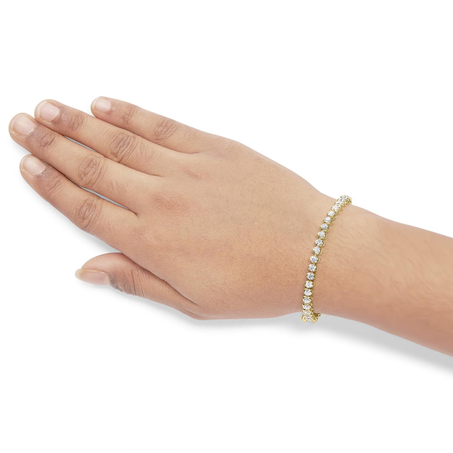 Yellow bracelet with round white gemstones in prong settings, shown on a model's wrist from a top-down angle.