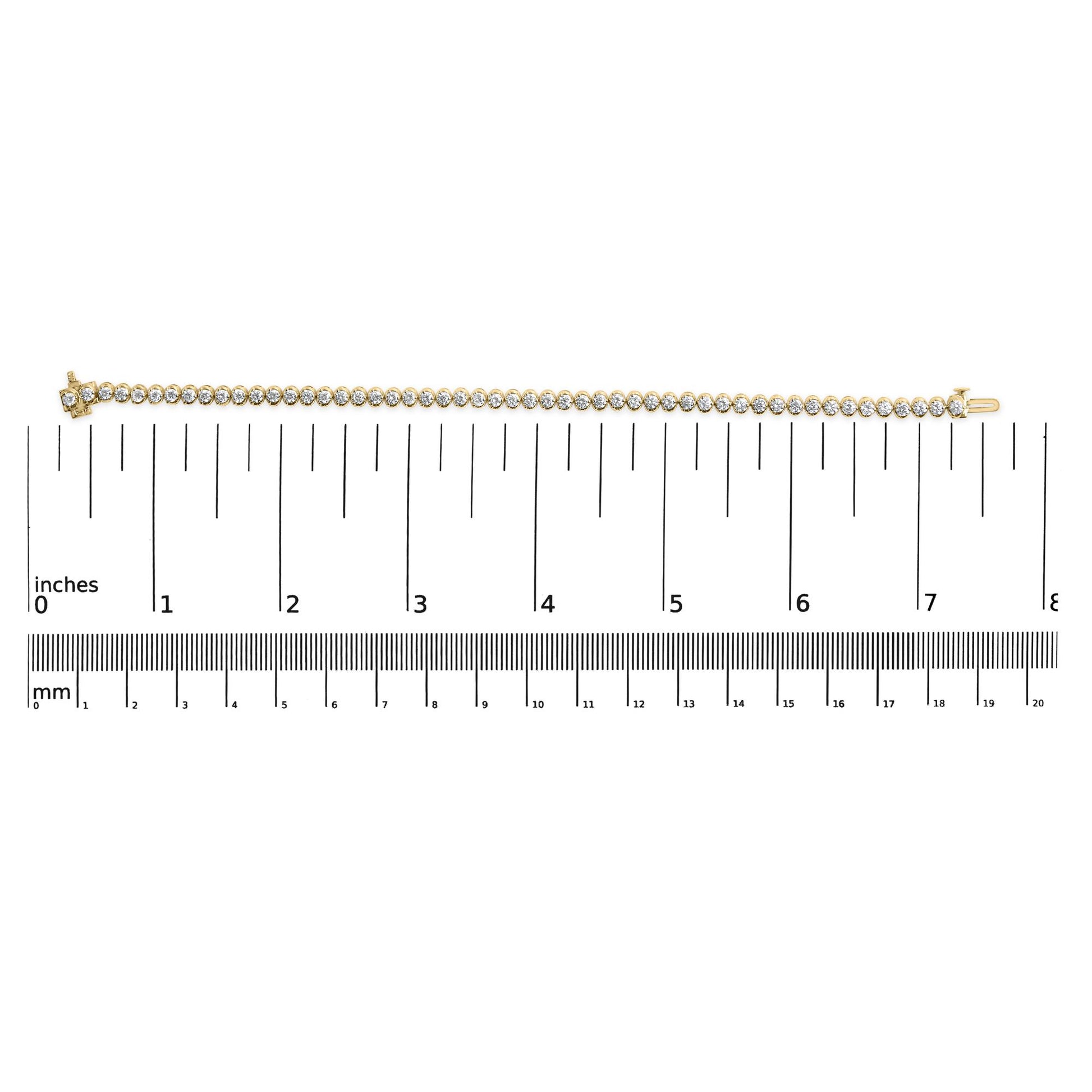 Straight yellow metal bracelet with round white gemstones in prong settings, laid flat on a ruler for size reference, top-down angle.