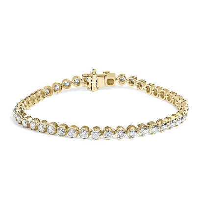 Yellow metal bracelet with round white gemstones in prong settings, shown in a close-up front view on a white background.