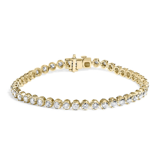 Yellow metal bracelet with round white gemstones in prong settings, shown in a close-up front view on a white background.