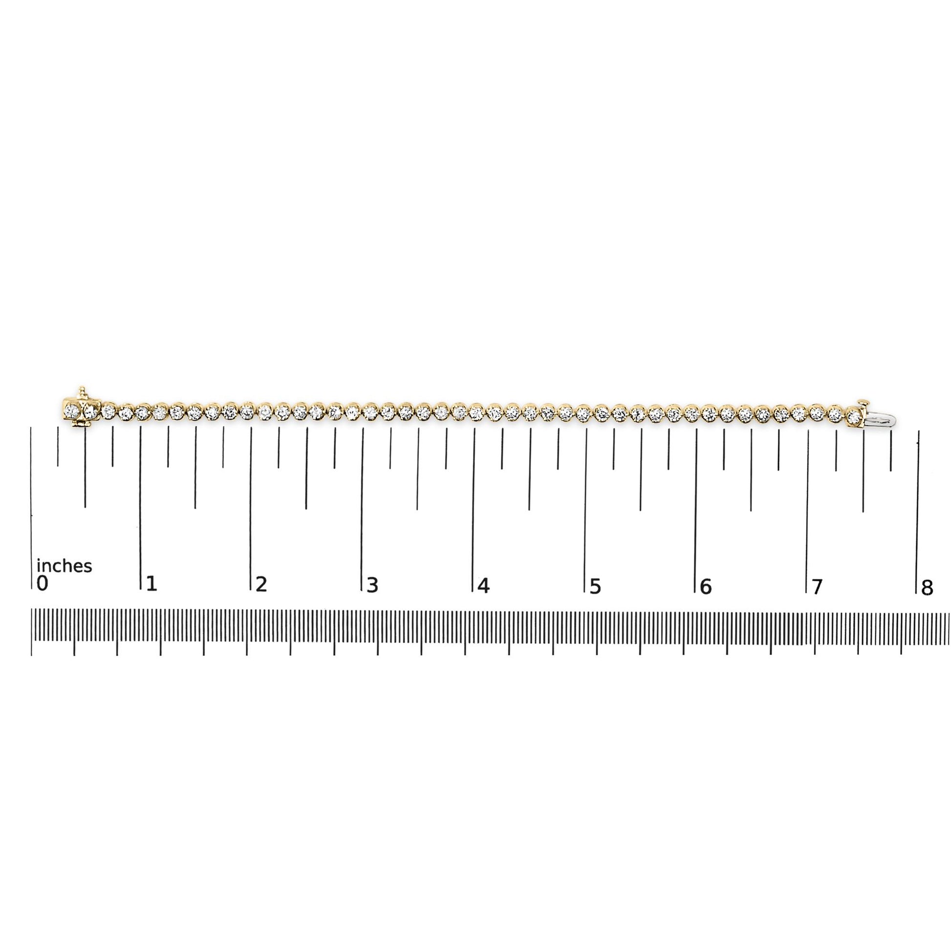 Close-up front view of a yellow metal bracelet with round white gemstones in prong settings, shown on a ruler scale.