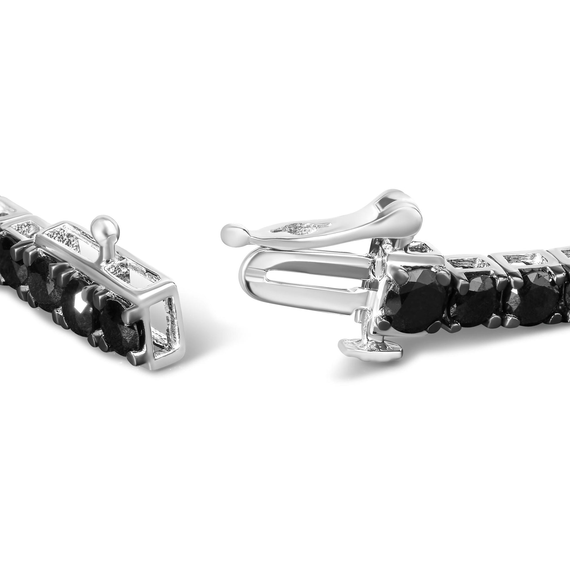 Close-up shot of a white metal bracelet featuring round black gemstones in prong settings, shown partially unclasped.