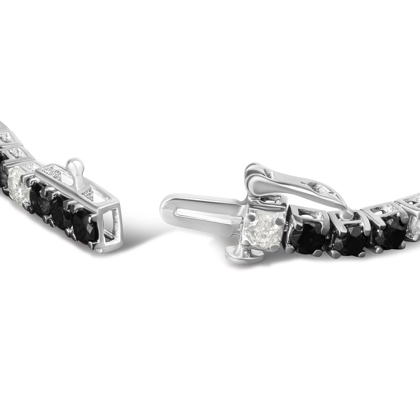 Close-up angled view of a white metal bracelet with alternating round black and white gemstones in 4-prong settings, showing the clasp open.