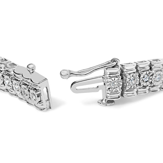 Close-up side angle of a white metal bracelet with round white gemstones in prong settings, showing the clasp mechanism.