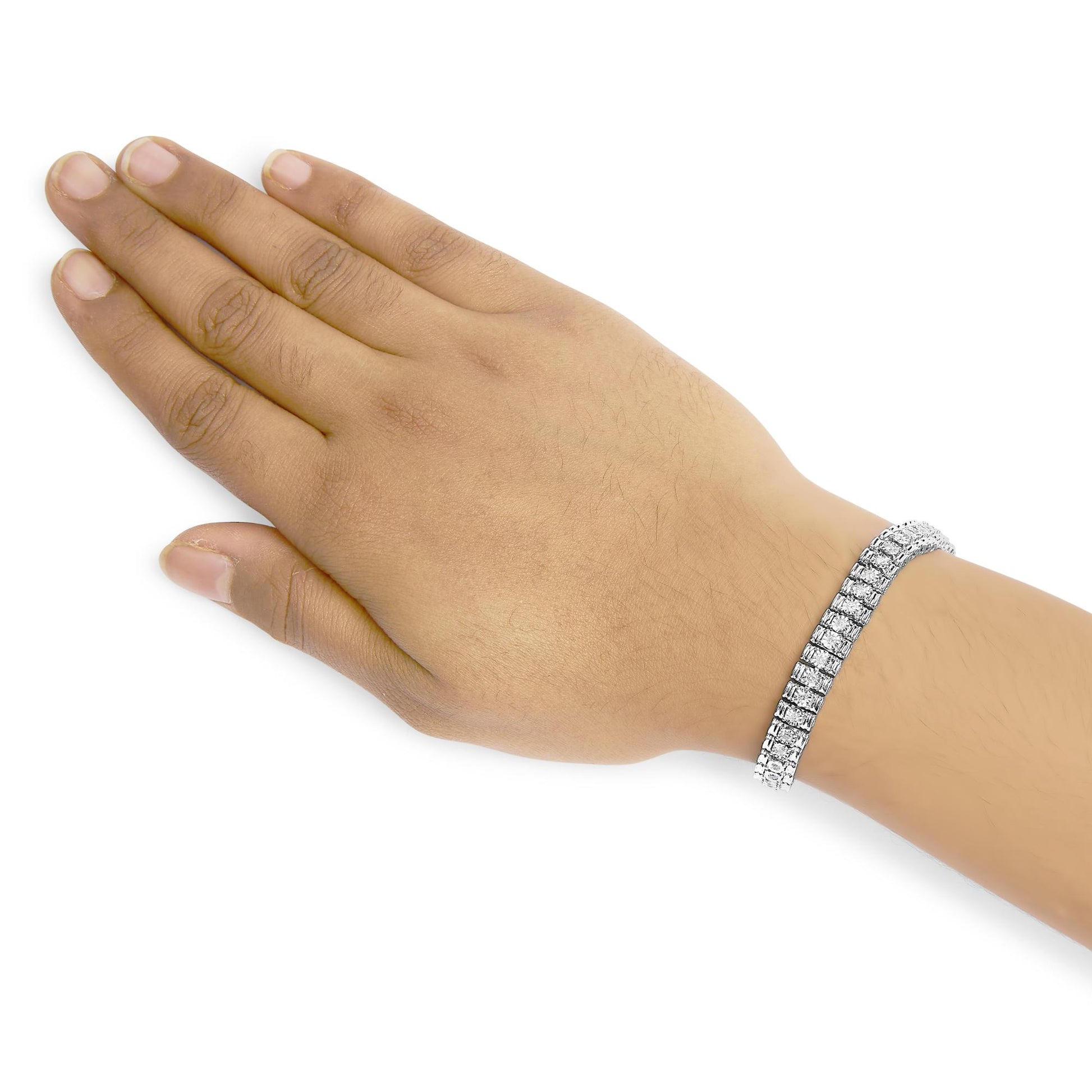 White metal bracelet with two rows of round white gemstones in prong settings, worn on model's wrist, shot from above.