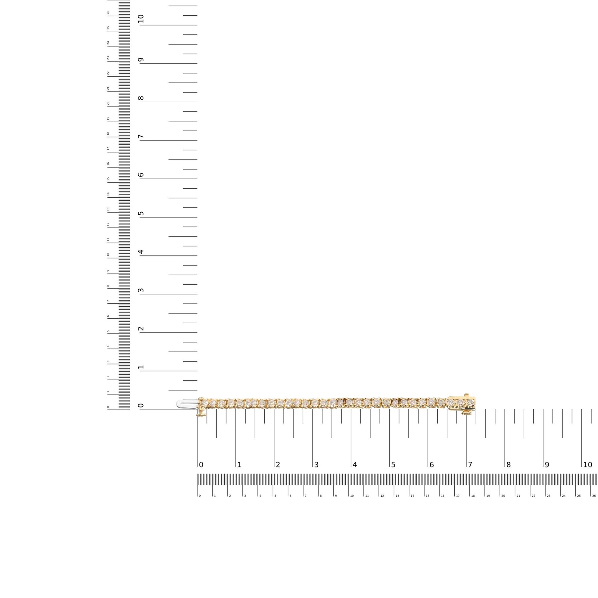 Yellow bracelet with round brownish gemstones in 4-prong settings, laid flat on a ruler for size reference, shot from above.