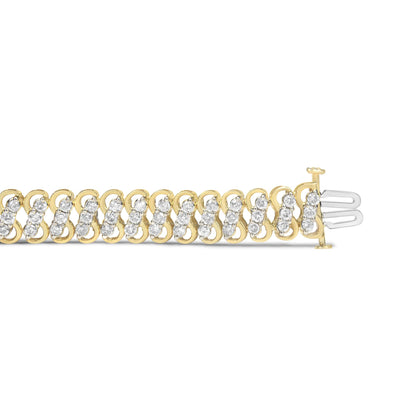 Close-up side angle of a yellow metal bracelet with alternating rows of round white gemstones in shared prong settings.