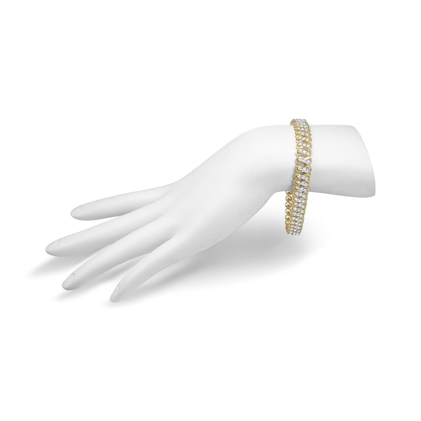 Yellow metal bracelet with white round gemstones in shared prong setting shown on a white display hand from a side angle.