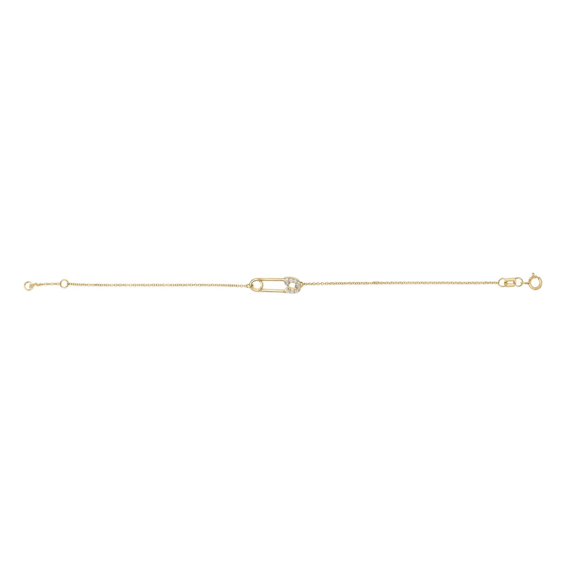 Yellow metal bracelet with a safety pin-shaped centerpiece adorned with white round gemstones, shown from a top-down angle on a white background.