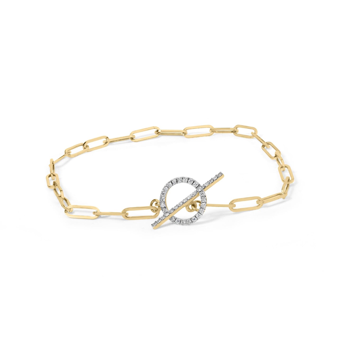 Yellow metal bracelet with elongated chain links featuring a circular toggle clasp adorned with white gemstones, photographed from an overhead angle.