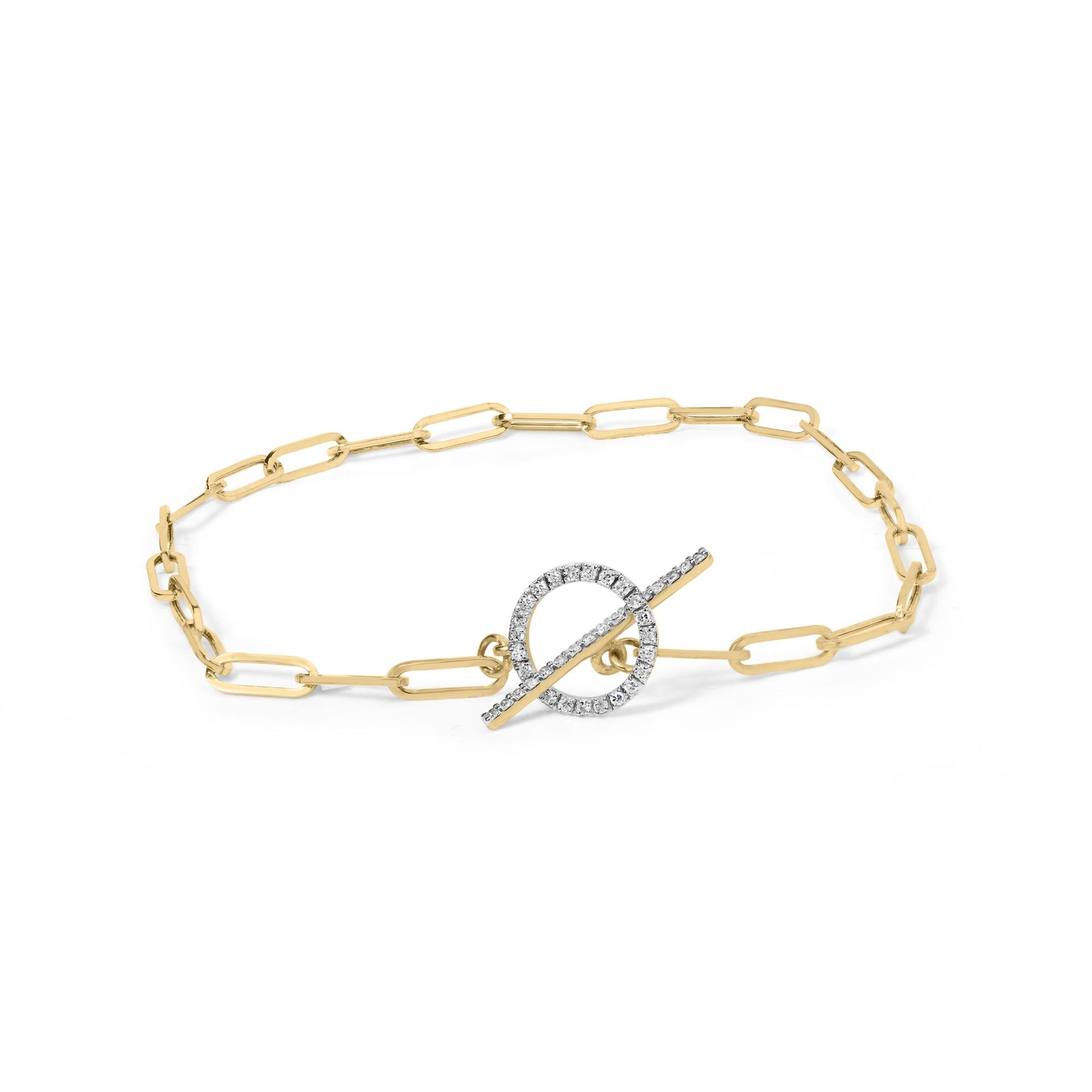 Yellow metal bracelet with elongated chain links featuring a circular toggle clasp adorned with white gemstones, photographed from an overhead angle.