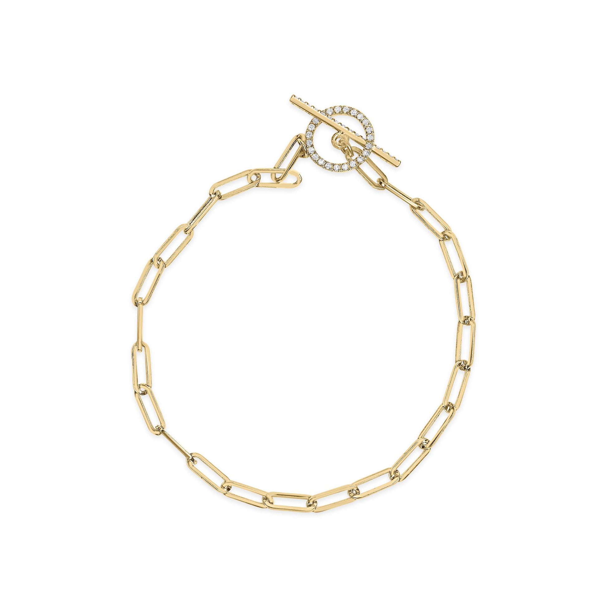 Top-down view of a yellow metal link bracelet with a toggle clasp featuring a circular element and bar adorned with white round gemstones in prong settings.