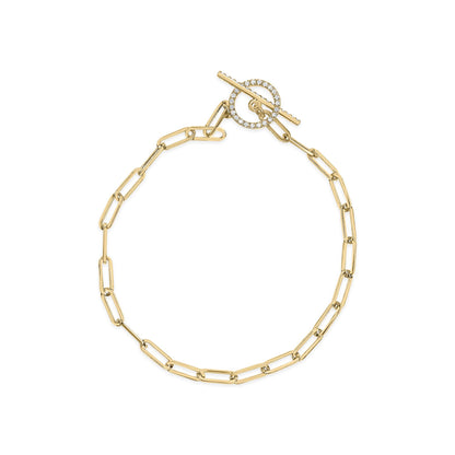 Top-down view of a yellow metal link bracelet with a toggle clasp featuring a circular element and bar adorned with white round gemstones in prong settings.