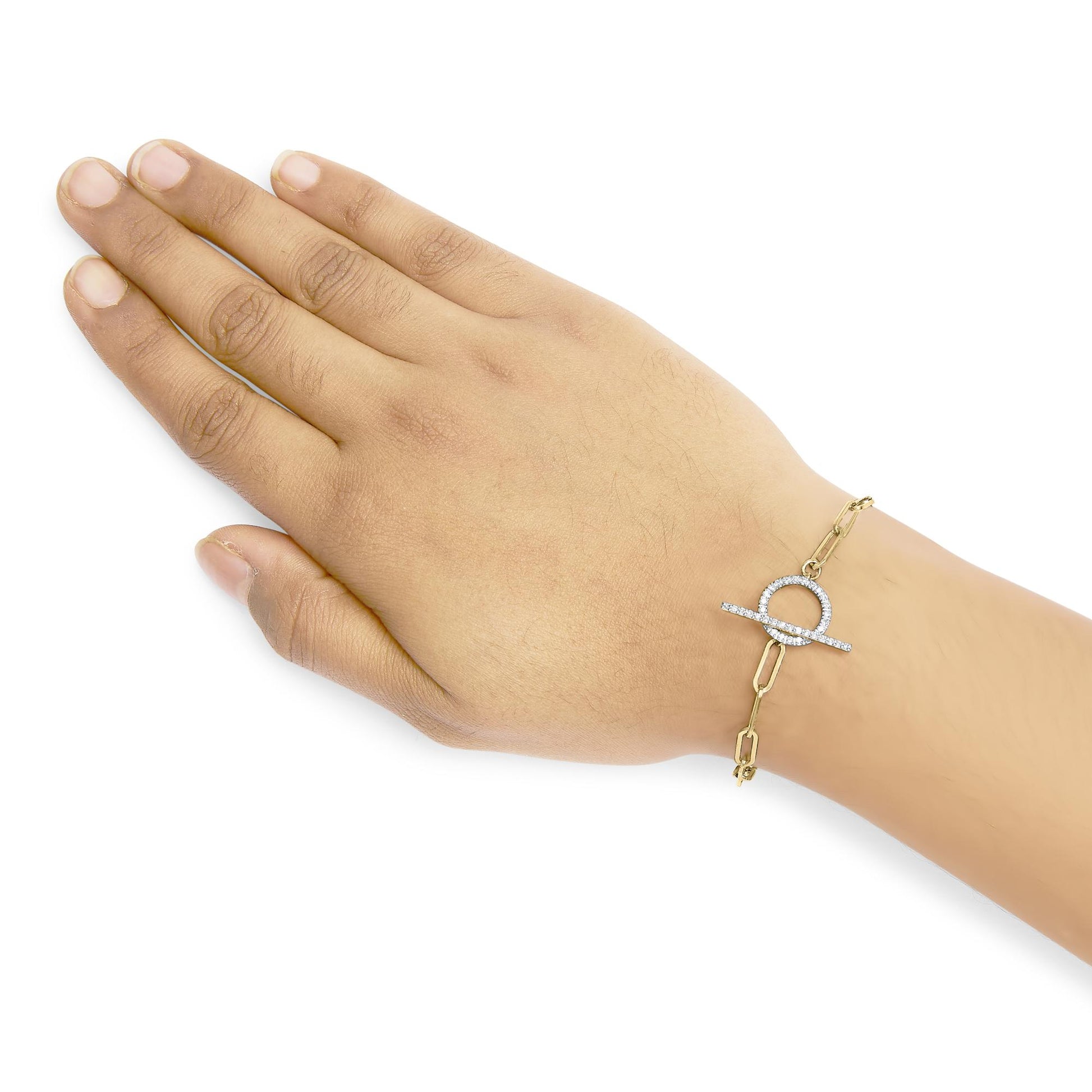 Yellow metal bracelet with a toggle clasp adorned with two rows of white round gemstones, shown on a model's hand from a top-down angle.