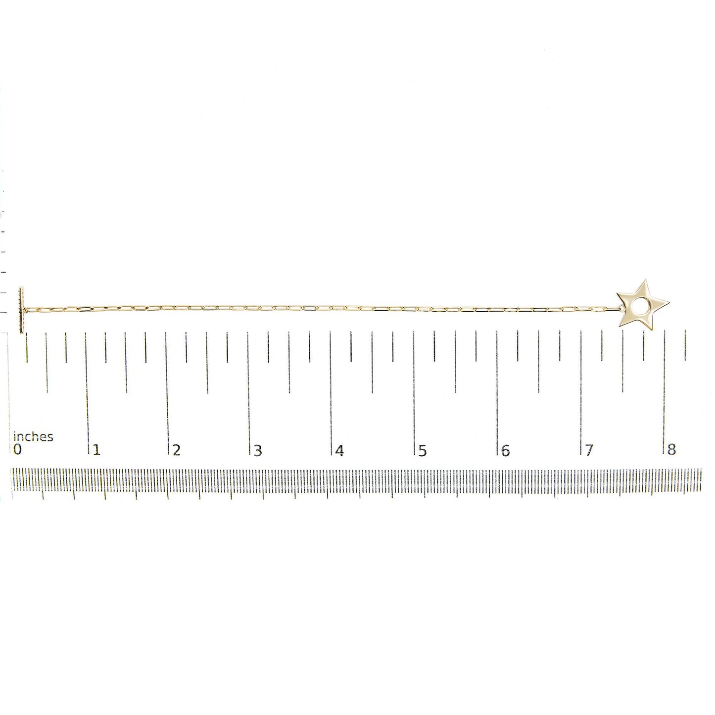 Yellow metal bracelet with a star-shaped charm, featuring round white gemstones in prong settings, shown on a scale from a top-down angle.