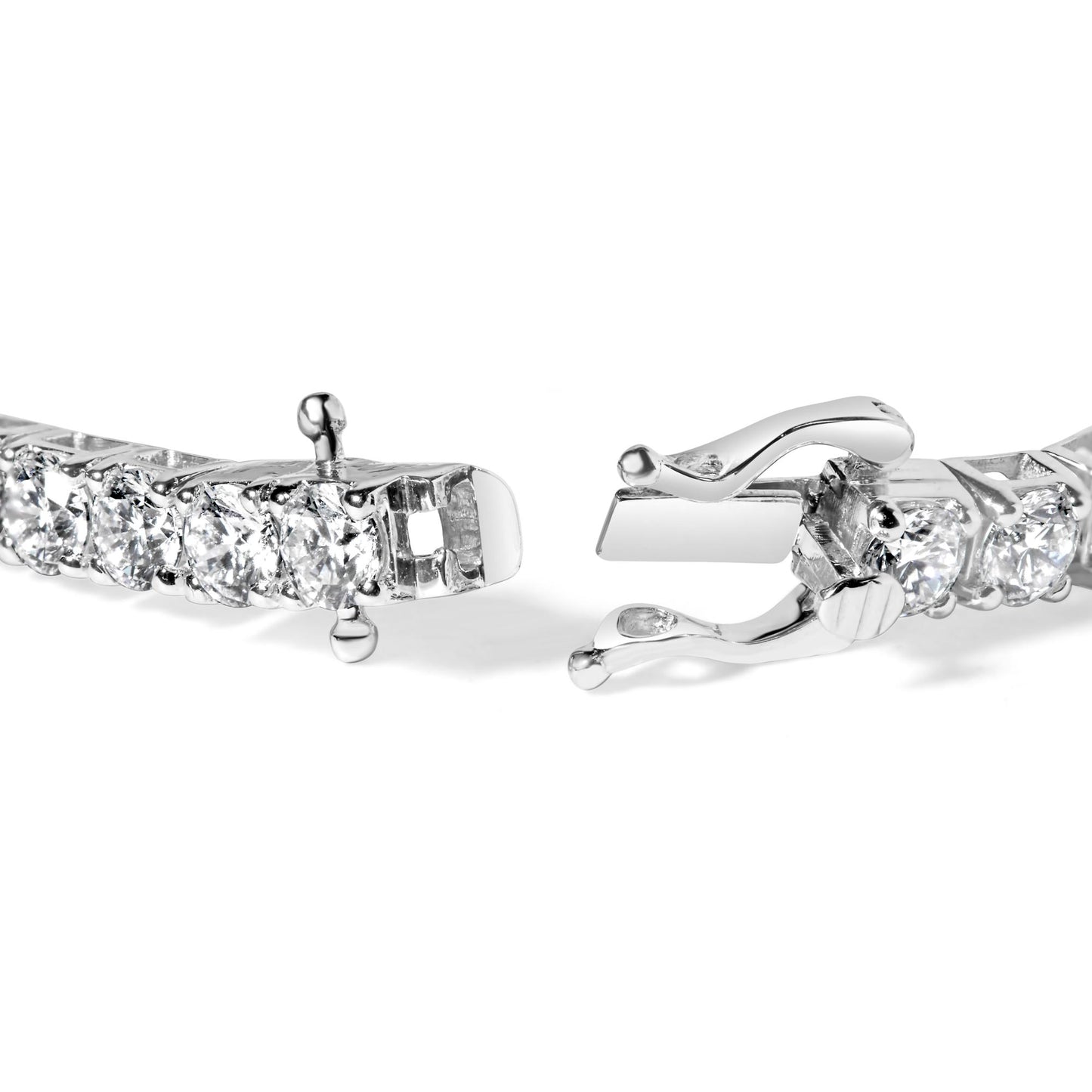 Close-up front angle of a white metal bracelet featuring round white gemstones in 4-prong settings with an open clasp.