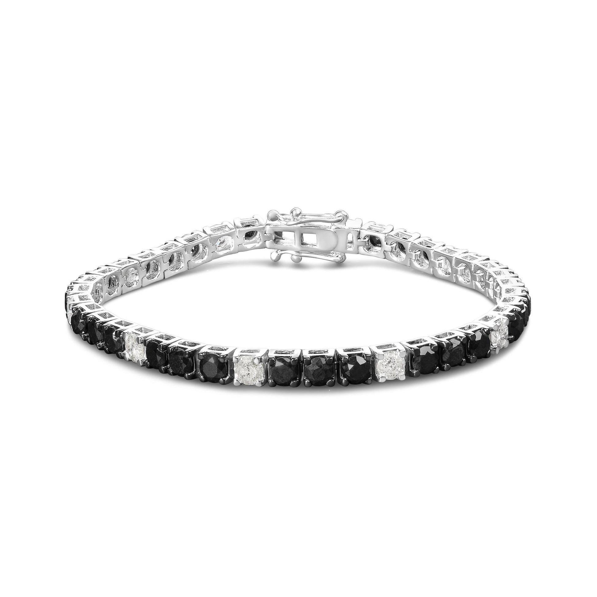 White metal bracelet with alternating black and white round gemstones in four-prong settings, shot at a slightly angled top view.
