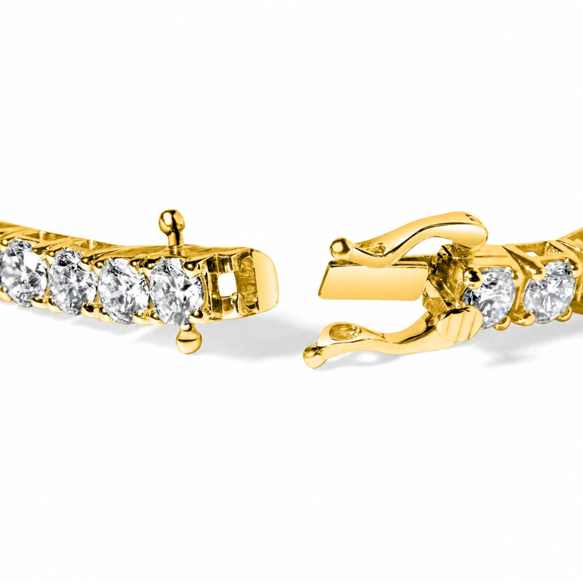 Close-up front angle of a yellow bracelet with round white gemstones in a 4-prong setting, shown unclasped on a white background.