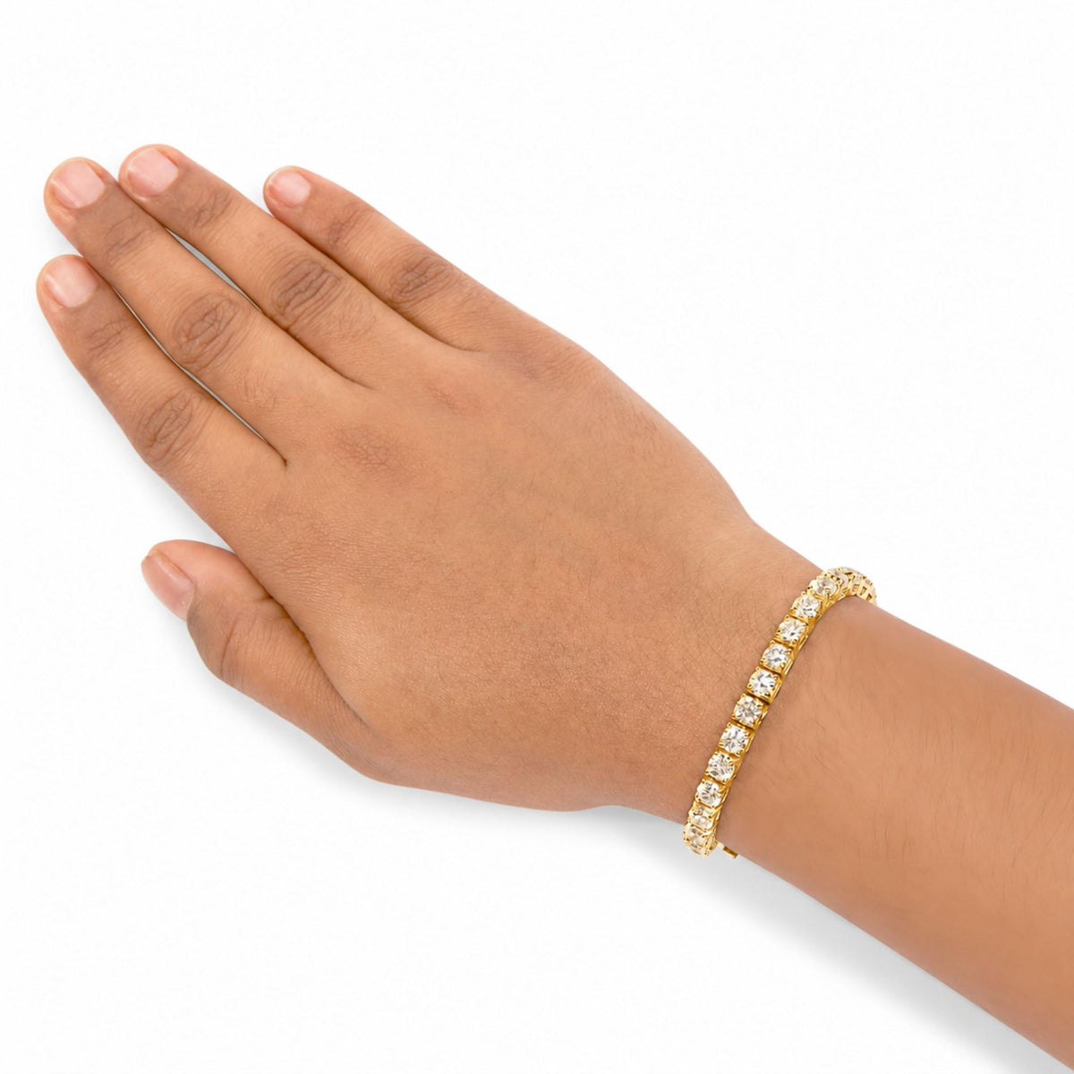 Close-up side angle of a model’s hand wearing a yellow metal bracelet featuring round white gemstones in a 4-prong setting.