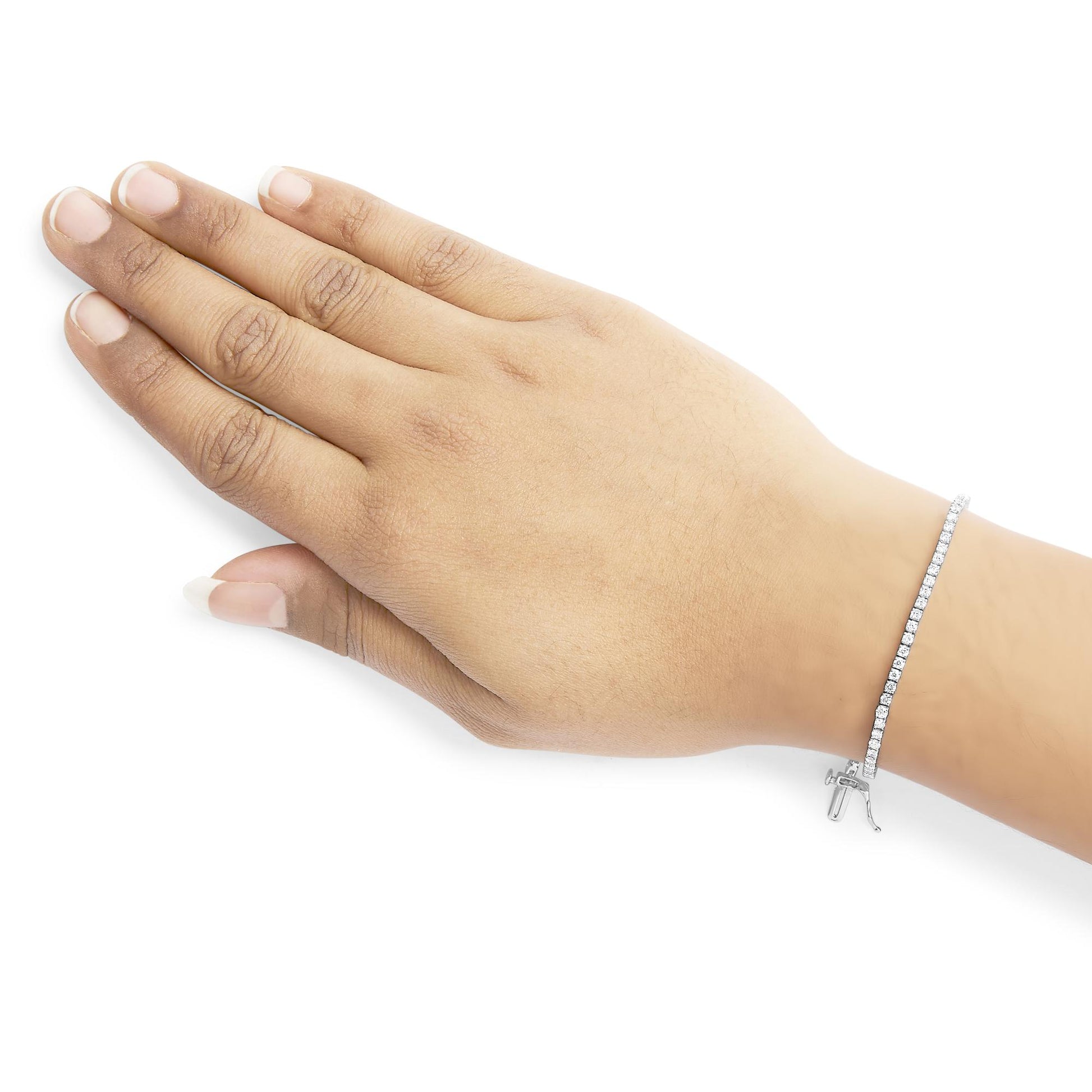 Close-up side angle of a hand wearing a white metal bracelet with round white gemstones in 4-prong settings.