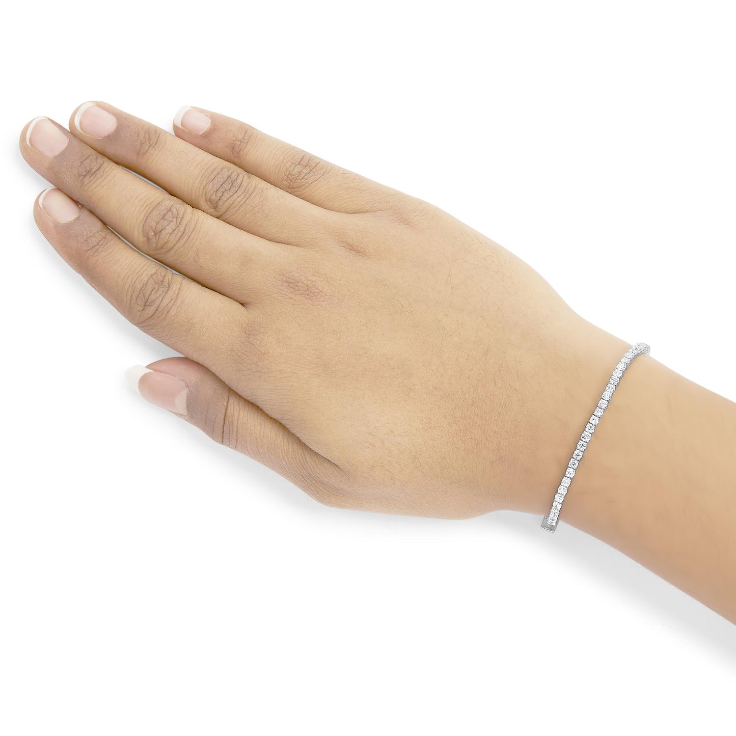 Close-up angled top view of a hand wearing a white metal bracelet set with round white gemstones in a 4-prong setting.