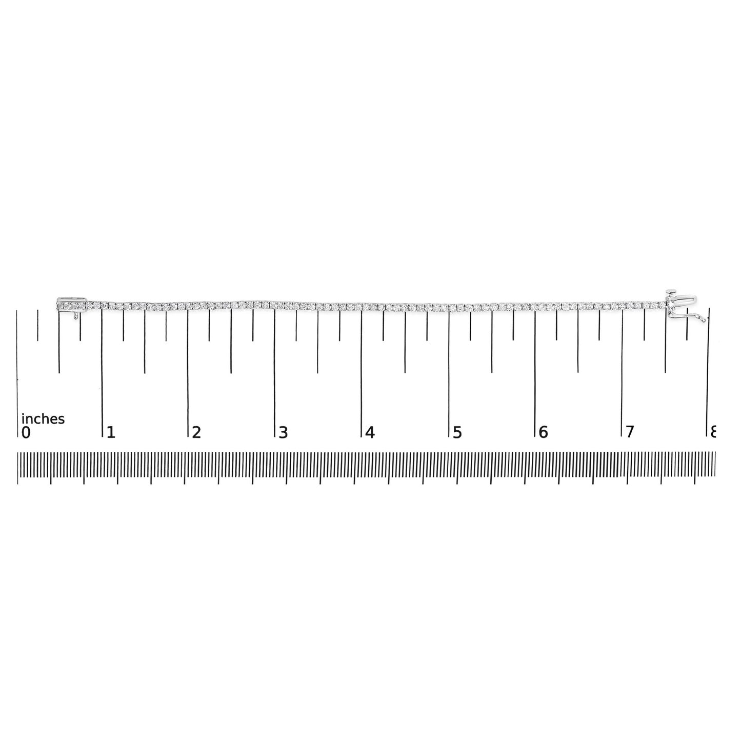 White metal tennis bracelet with round white gemstones in four-prong settings, laid flat on a ruler for size reference, top-down angle.