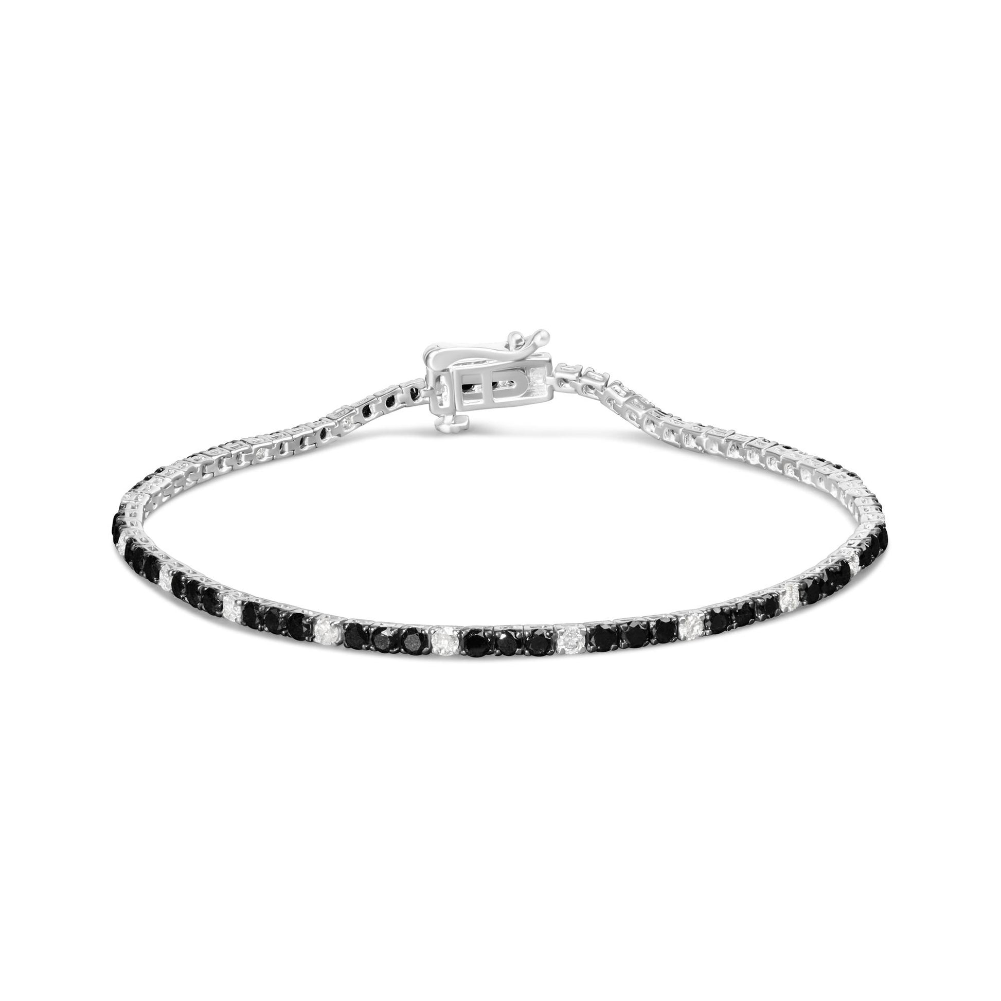 Front-facing view of a white bracelet with alternating black and white round gemstones in 4-prong settings with the clasp visible.