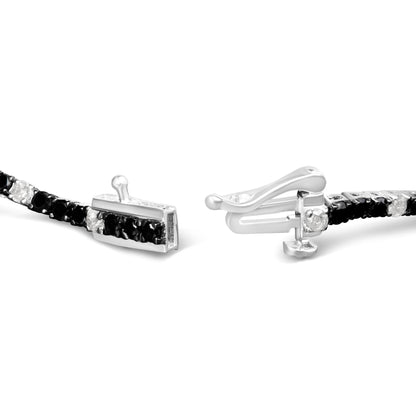 Close-up front angle of a white metal bracelet featuring alternating black and white round gemstones in 4-prong settings, showing the clasp details.