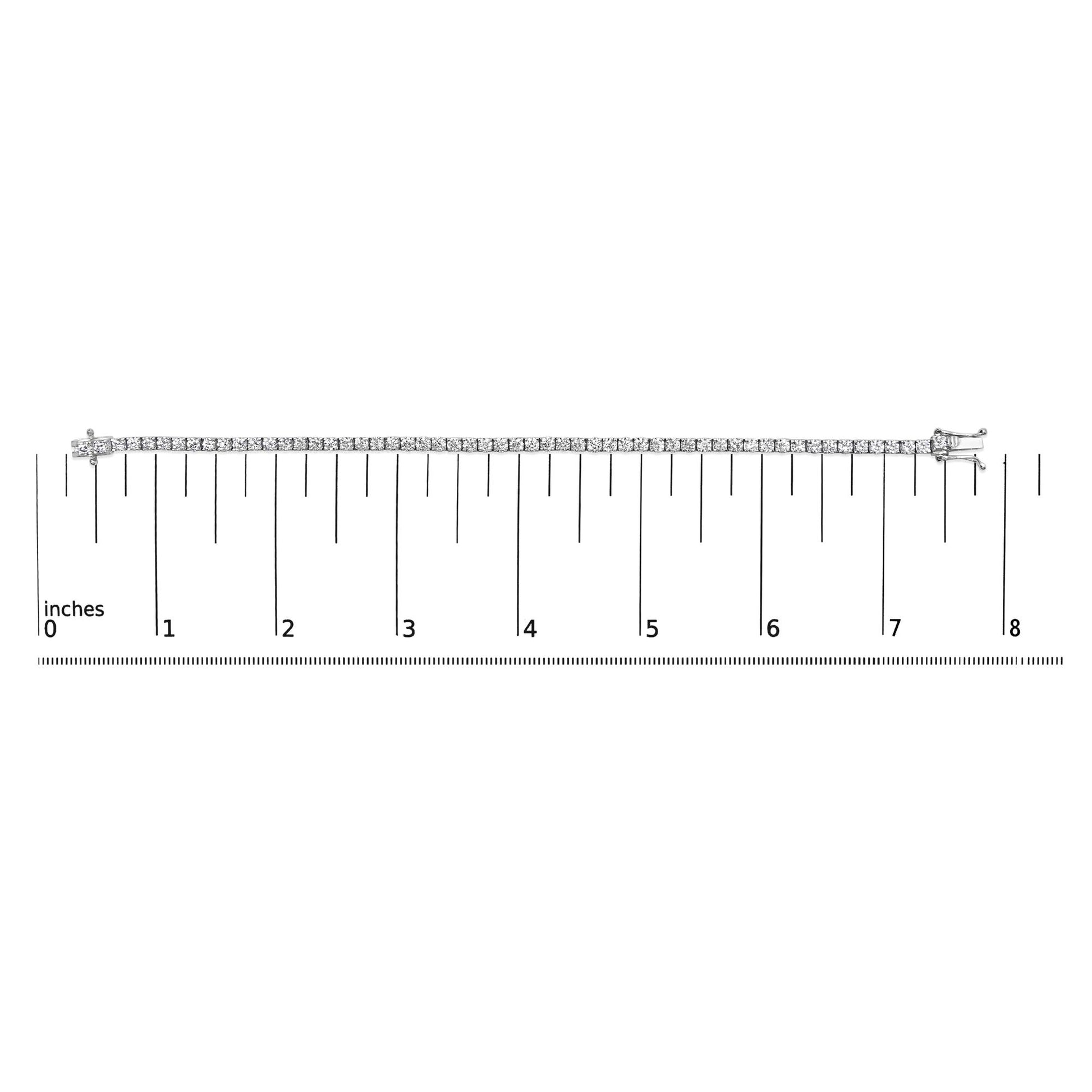 White metal bracelet with two rows of round-shaped white gemstones in four-prong settings, laid flat on a ruler for size reference, shot from above.