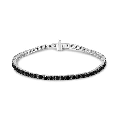 White bracelet with round black gemstones in prong settings, shown at a slight top front angle.