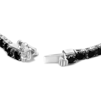 Close-up angled view of a white metal bracelet featuring round black gemstones set in prongs with a box clasp partially open.
