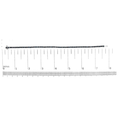 White metal bracelet with round black gemstones in prong setting, displayed flat on a ruler for size reference, top-down view.
