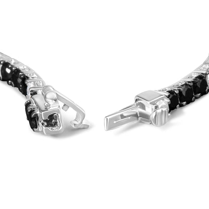 Close-up front angle of a white metal bracelet with an open clasp, featuring round black and white gemstones in 4-prong settings along the band.