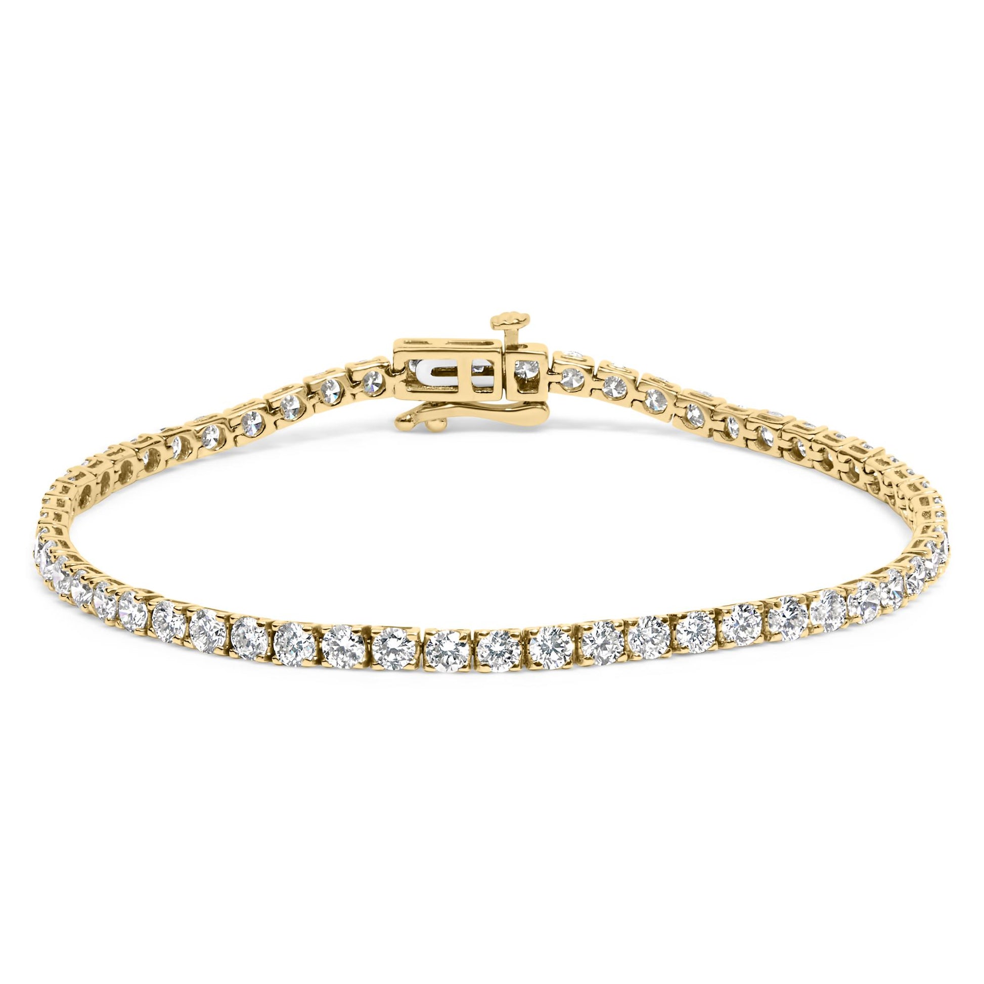 Yellow metal bracelet with round white gemstones in 4-prong settings, shown from a front angled perspective.
