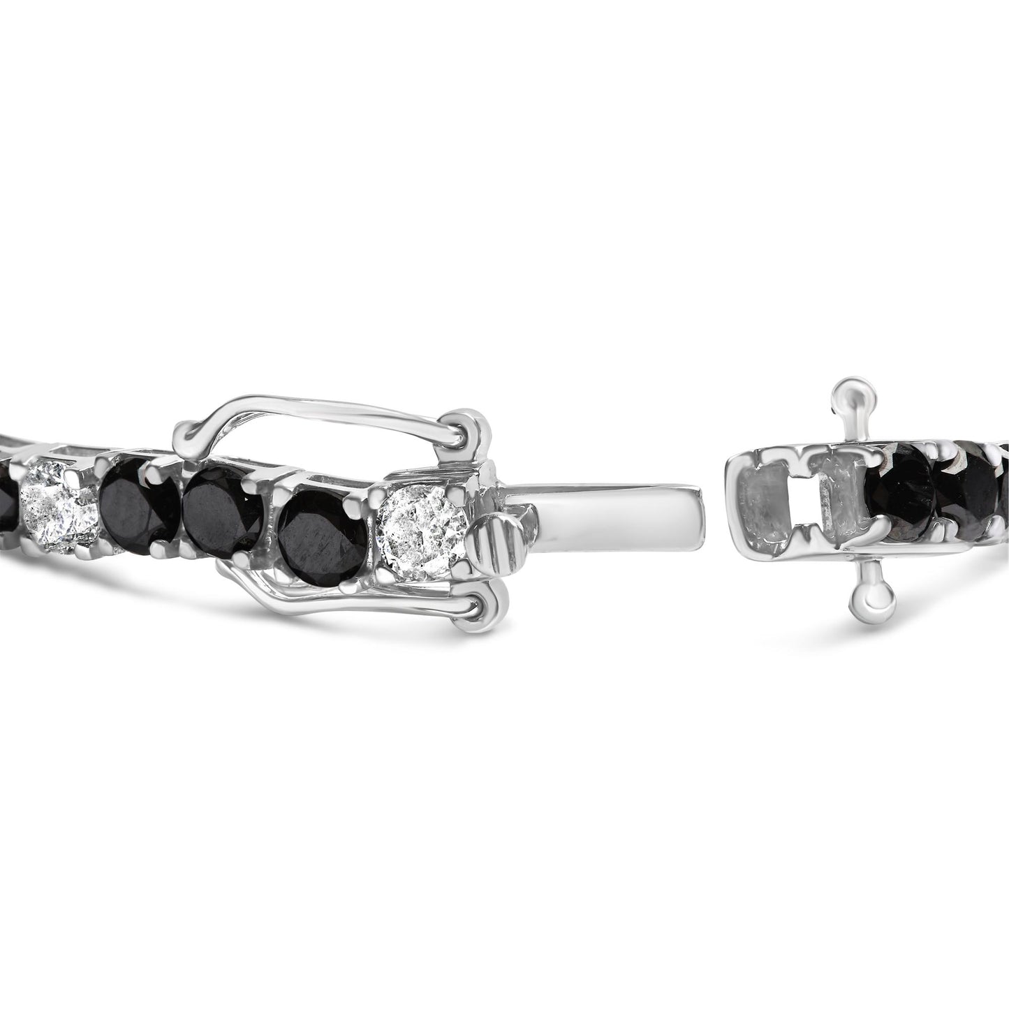 Close-up front angle of a white metal bracelet with alternating round white and black gemstones in four-prong settings, showing the clasp details.