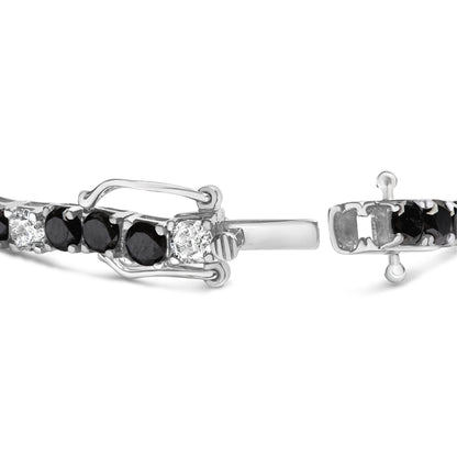 Close-up front angle of a white metal bracelet with alternating round white and black gemstones in four-prong settings, showing the clasp details.