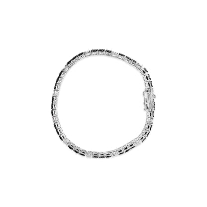 Top-down view of a white metal bracelet set with alternating white and black round gemstones in 4-prong settings.