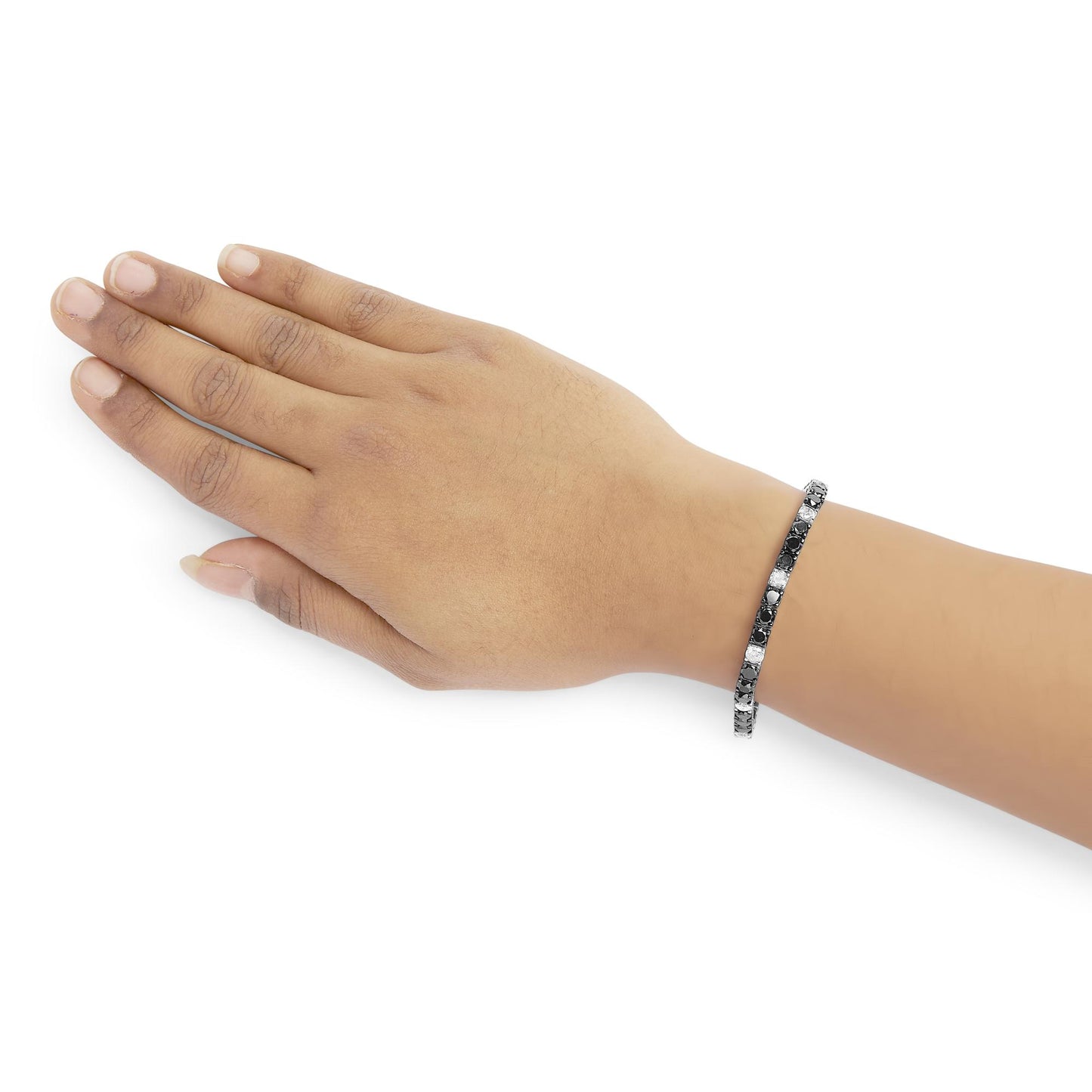 White metal bracelet with alternating white and black round gemstones in 4-prong settings, shown on a model's wrist, angled top-down.