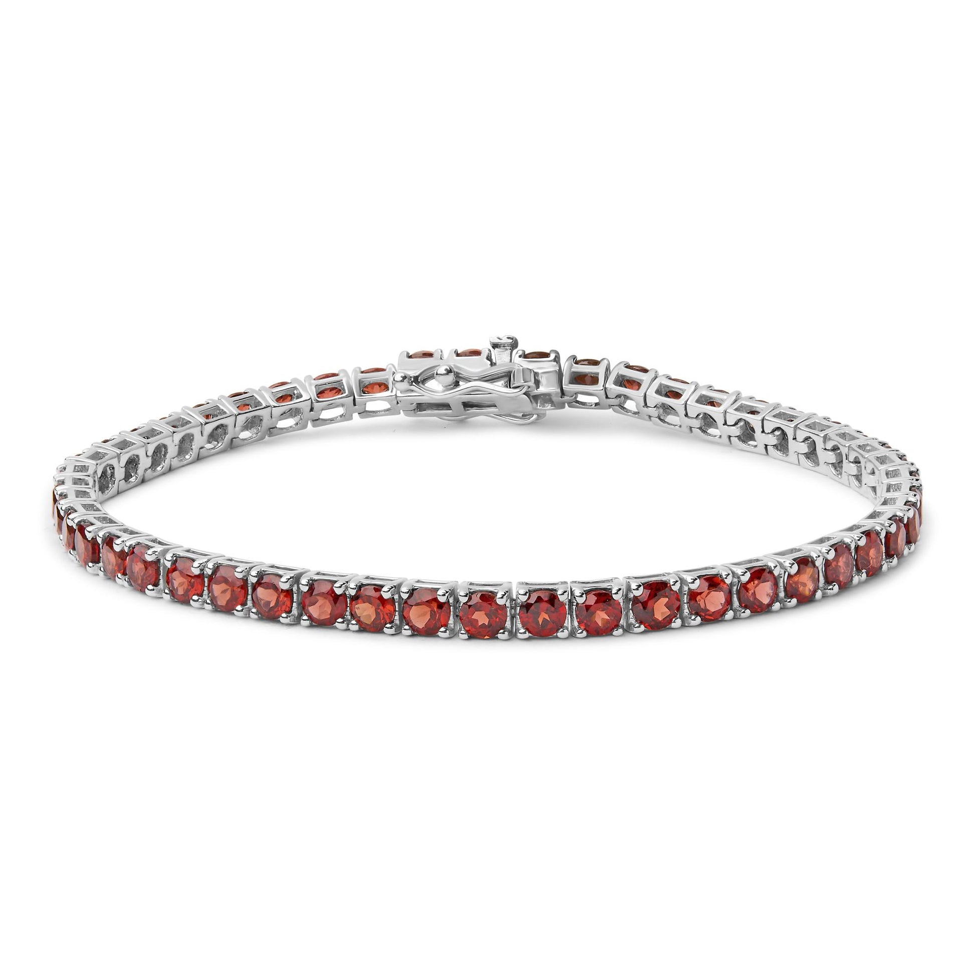 White metal bracelet with round orange gemstones in four-prong settings, shown from a slight top angle.