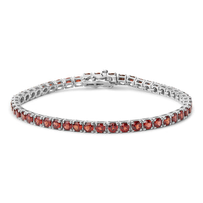 White metal bracelet with round orange gemstones in four-prong settings, shown from a slight top angle.