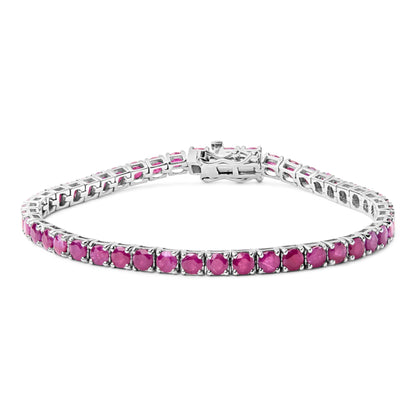 White metal bracelet with round pink gemstones set in four-prong settings, shown in a slightly angled top view.