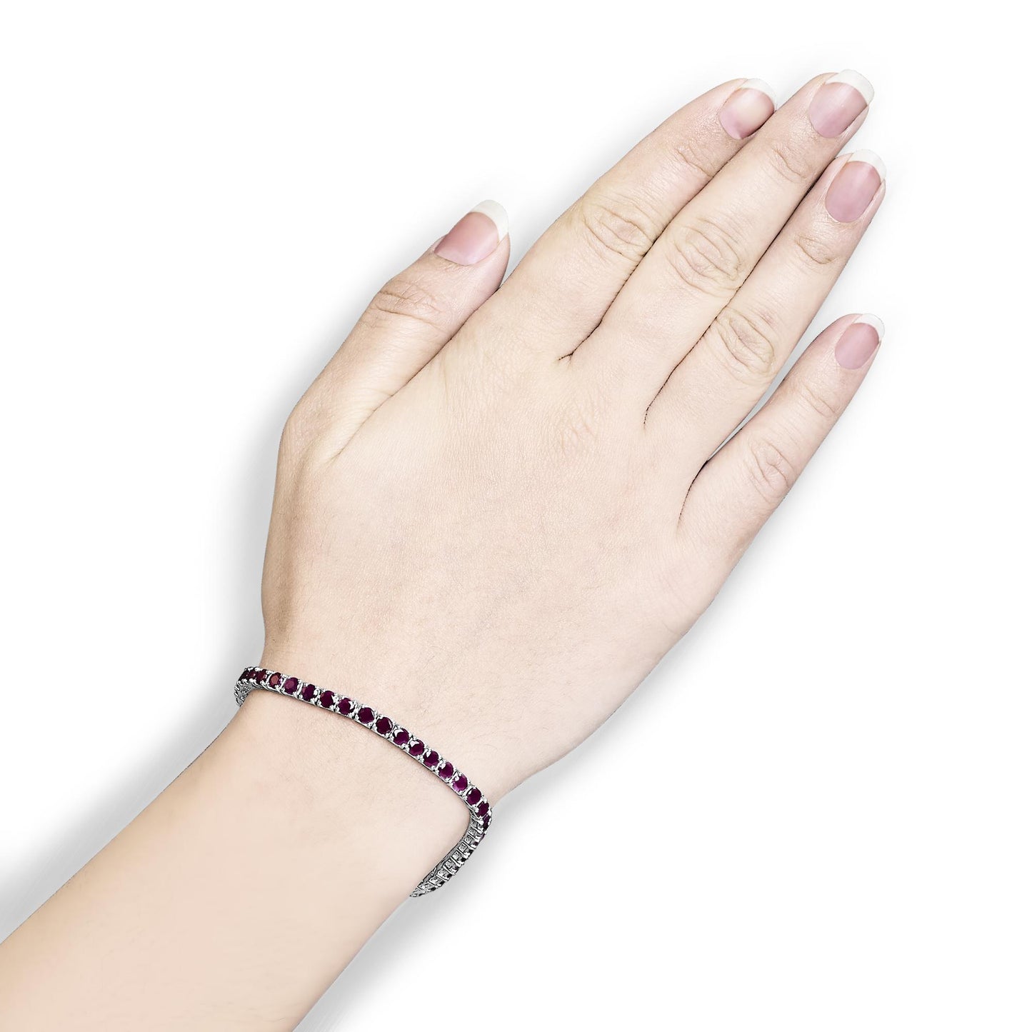 White metal bracelet with round pink gemstones in 4-prong settings, shown on a model's wrist, top-down angle.