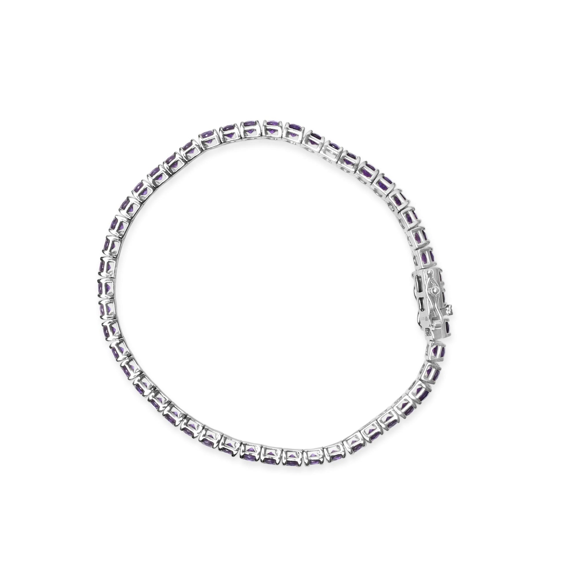 Top-down view of a white metal bracelet with round purple gemstones in 4-prong settings linked together in a continuous circle.